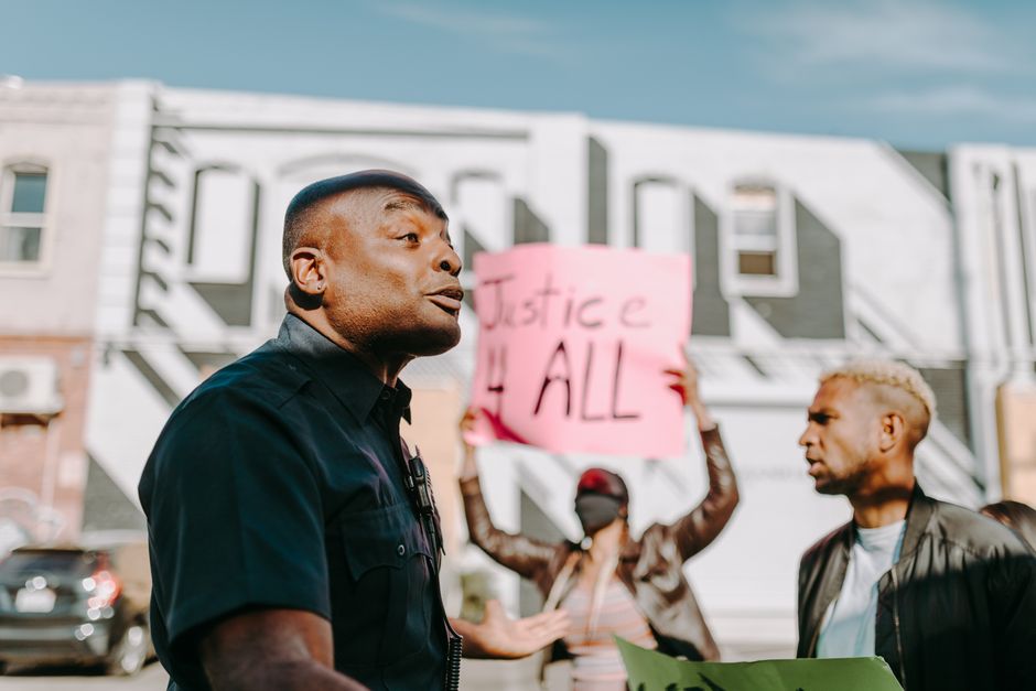 Protesters rallying for justice and equality in a city setting.